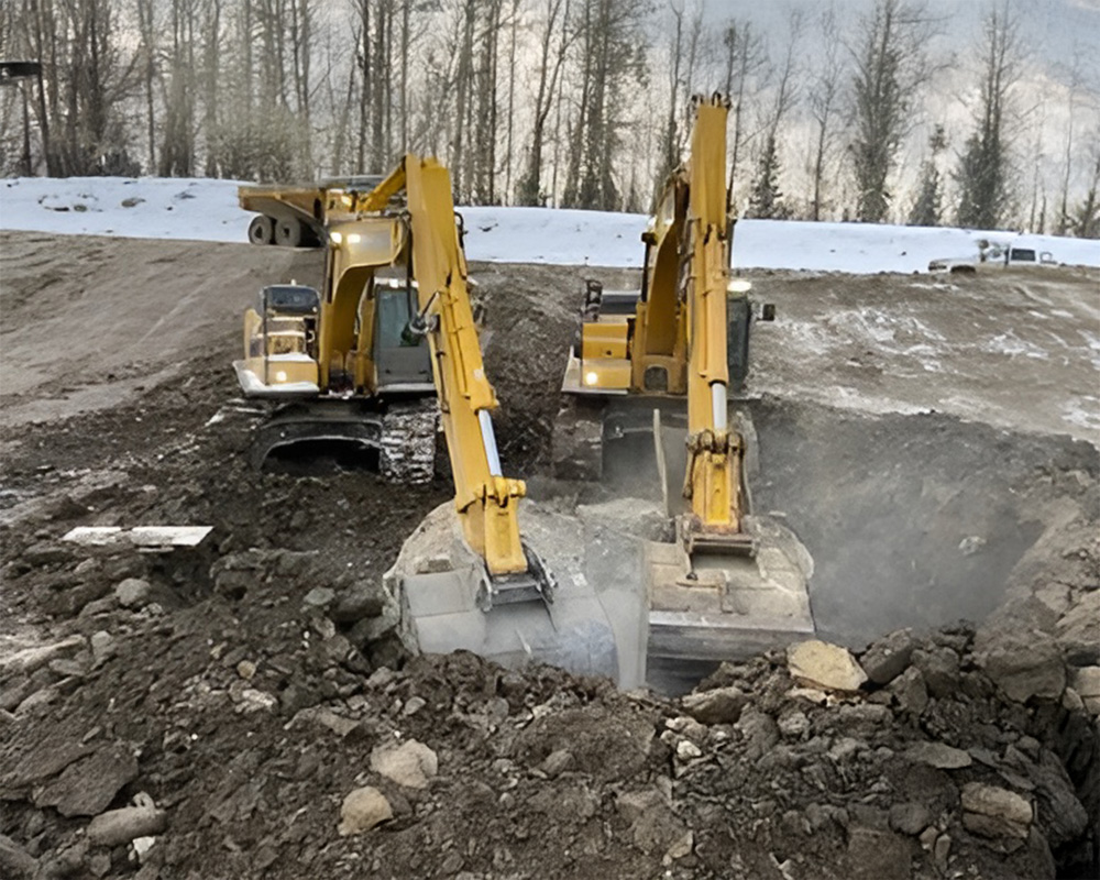 excavator digging up boulder