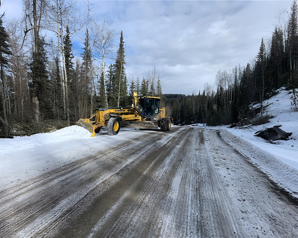 grader maintaining oilfield road