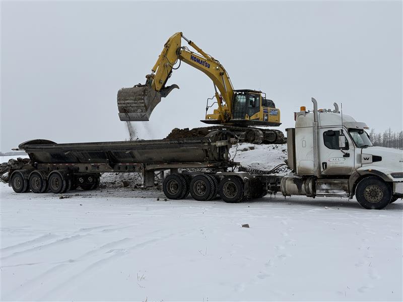 dirty-dirt-hauling service image excavator side dump contaminated soil ACL Construction